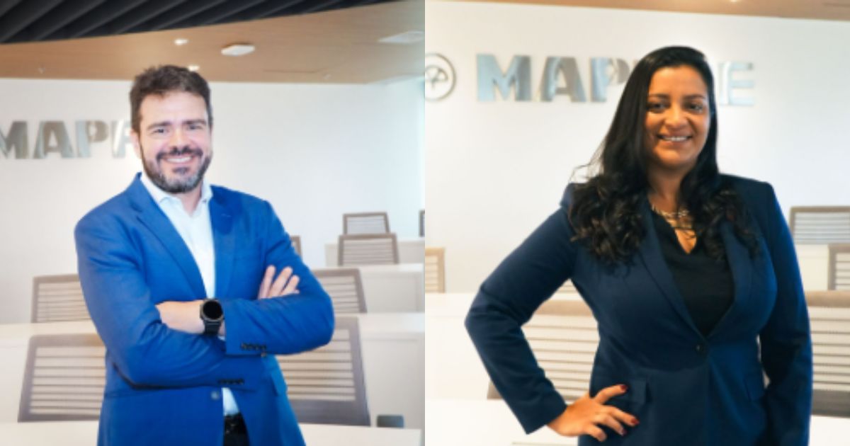 A imagem está dividida em duas partes. À esquerda, um homem com barba curta e cabelos castanhos está sorrindo, vestindo um fato azul com camisa branca e relógio no pulso. Ele está com os braços cruzados e posando confiante. À direita, uma mulher de cabelos longos e pretos também sorri, vestindo um blazer azul-escuro e uma blusa preta. Ela está com uma das mãos na cintura e transmite uma postura profissional. O fundo, em ambas as partes da imagem, exibe um ambiente corporativo com cadeiras e mesas em tons neutros, além de um logotipo grande na parede escrito "MAP"